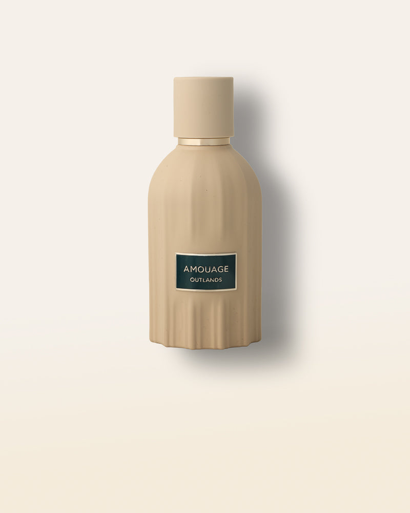 Amouage Outlands is a bold oriental woody Essence de Parfum built around cardamom, incense, patchouli, and glowing amber.