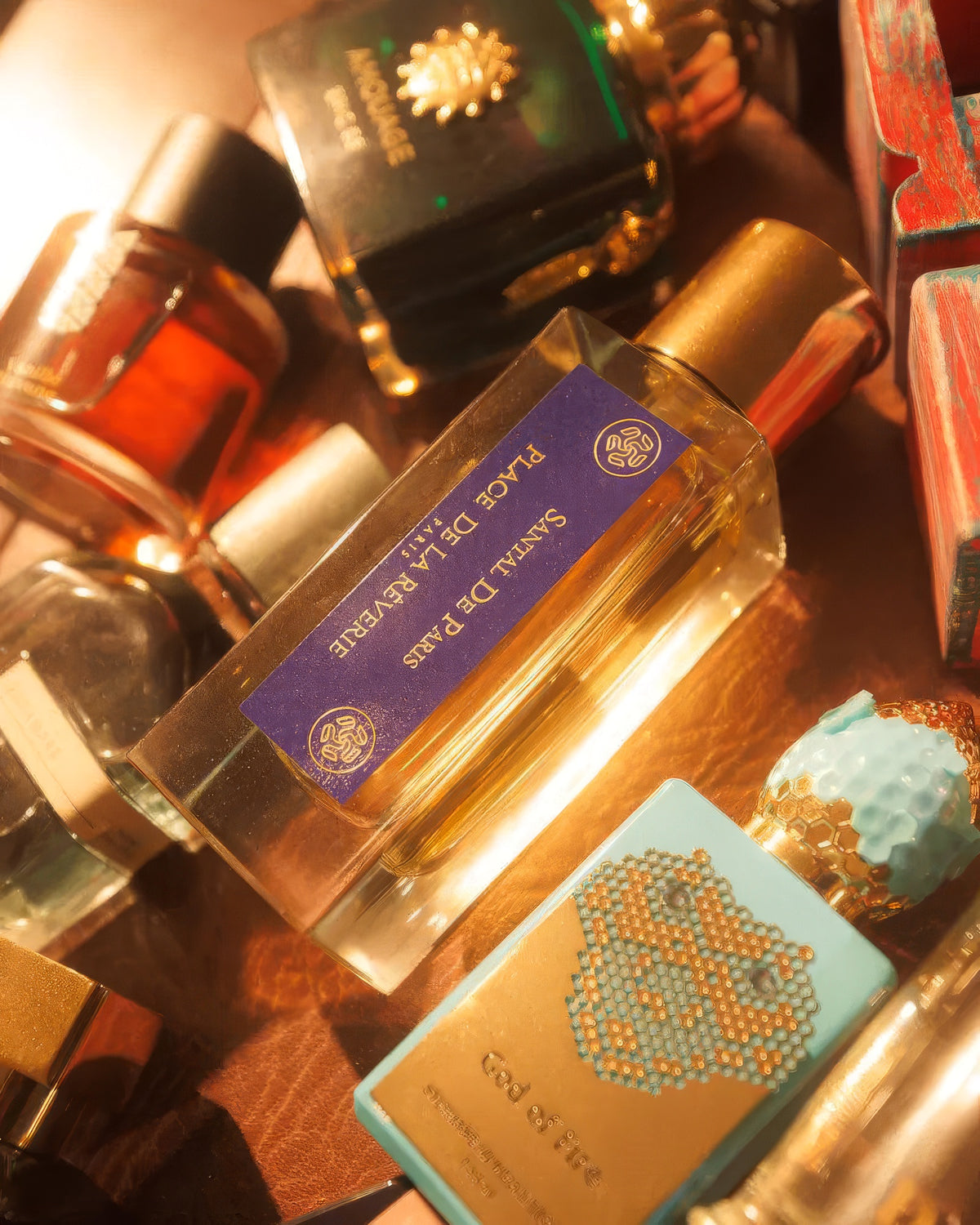 Place de la Rêverie Santal de Paris flacon among niche perfume bottles in warm golden light, sandalwood extrait sample