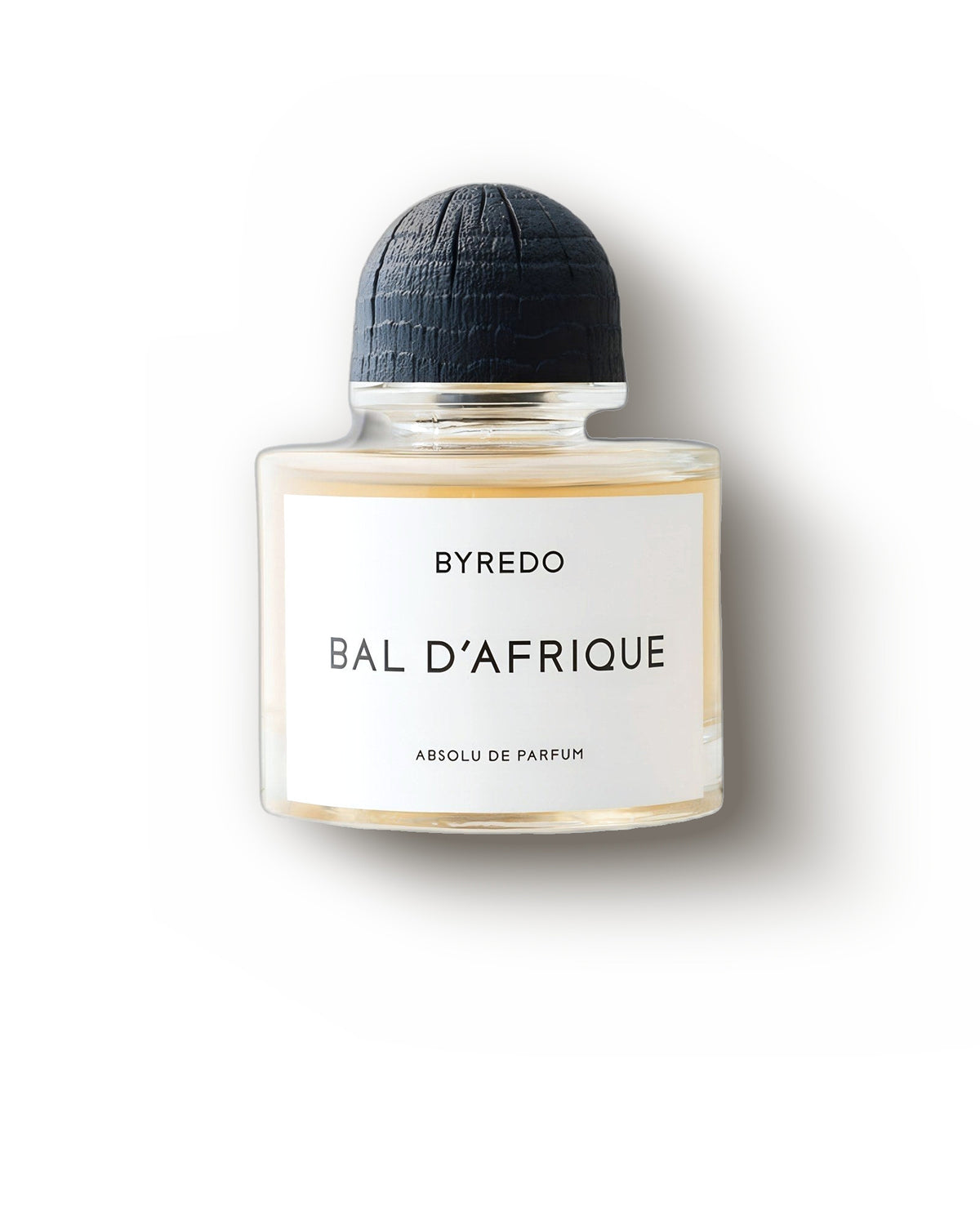 Byredo Bal d'Afrique Absolu botol bening dengan tutup hitam berkubah di atas abu-abu lembut, decant parfum niche kayu