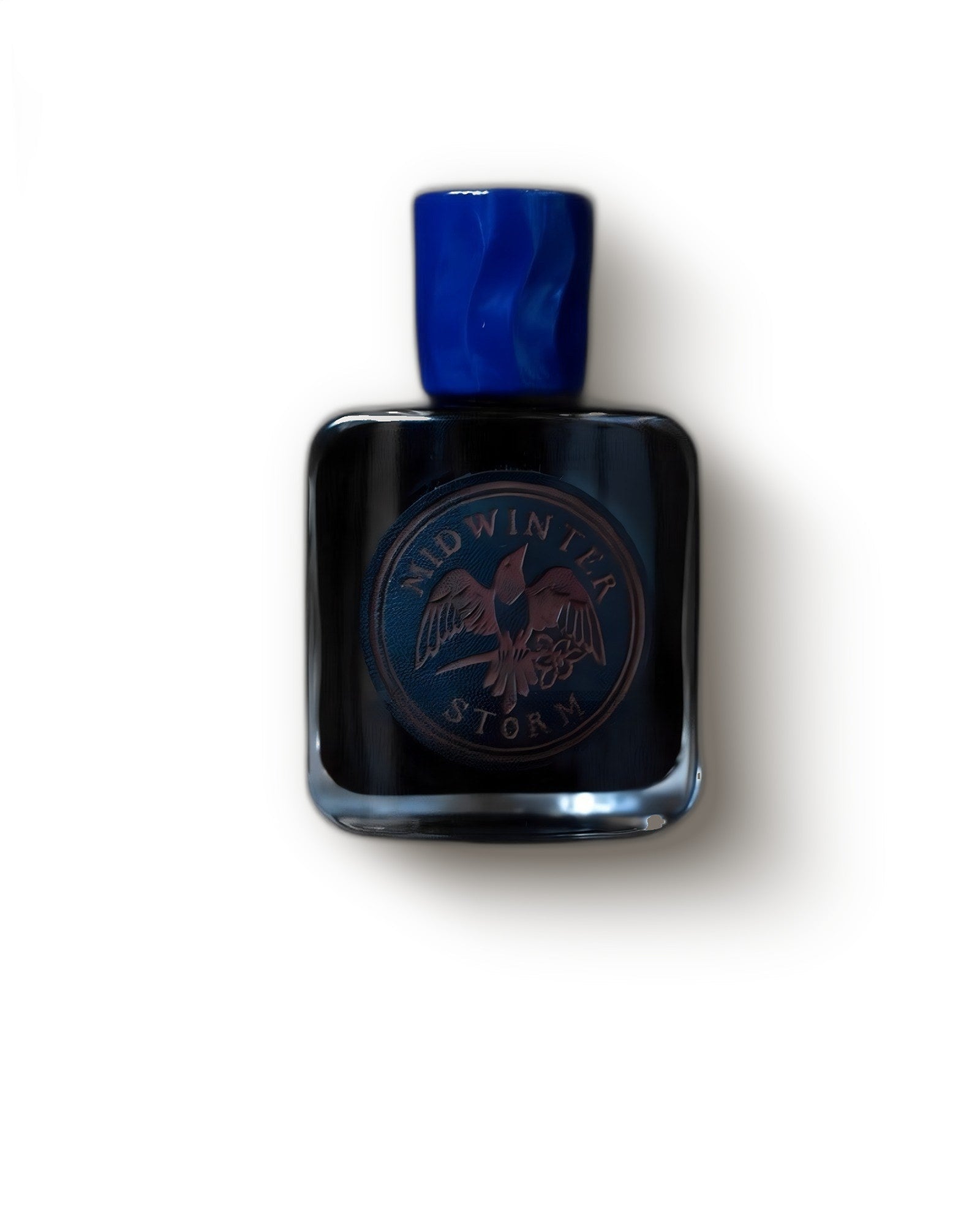 Folkwinds Midwinter Storm black bottle with marbled blue cap and bird crest on cream, woody extrait de parfum decant