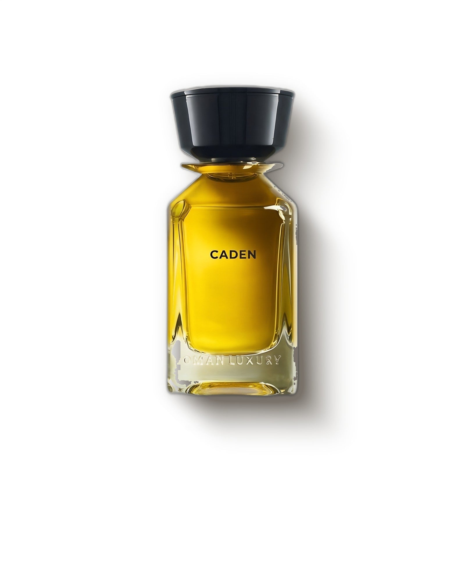 Oman Luxury Caden amber bottle with wide black cap on a soft grey backdrop, smoky oud eau de parfum decant