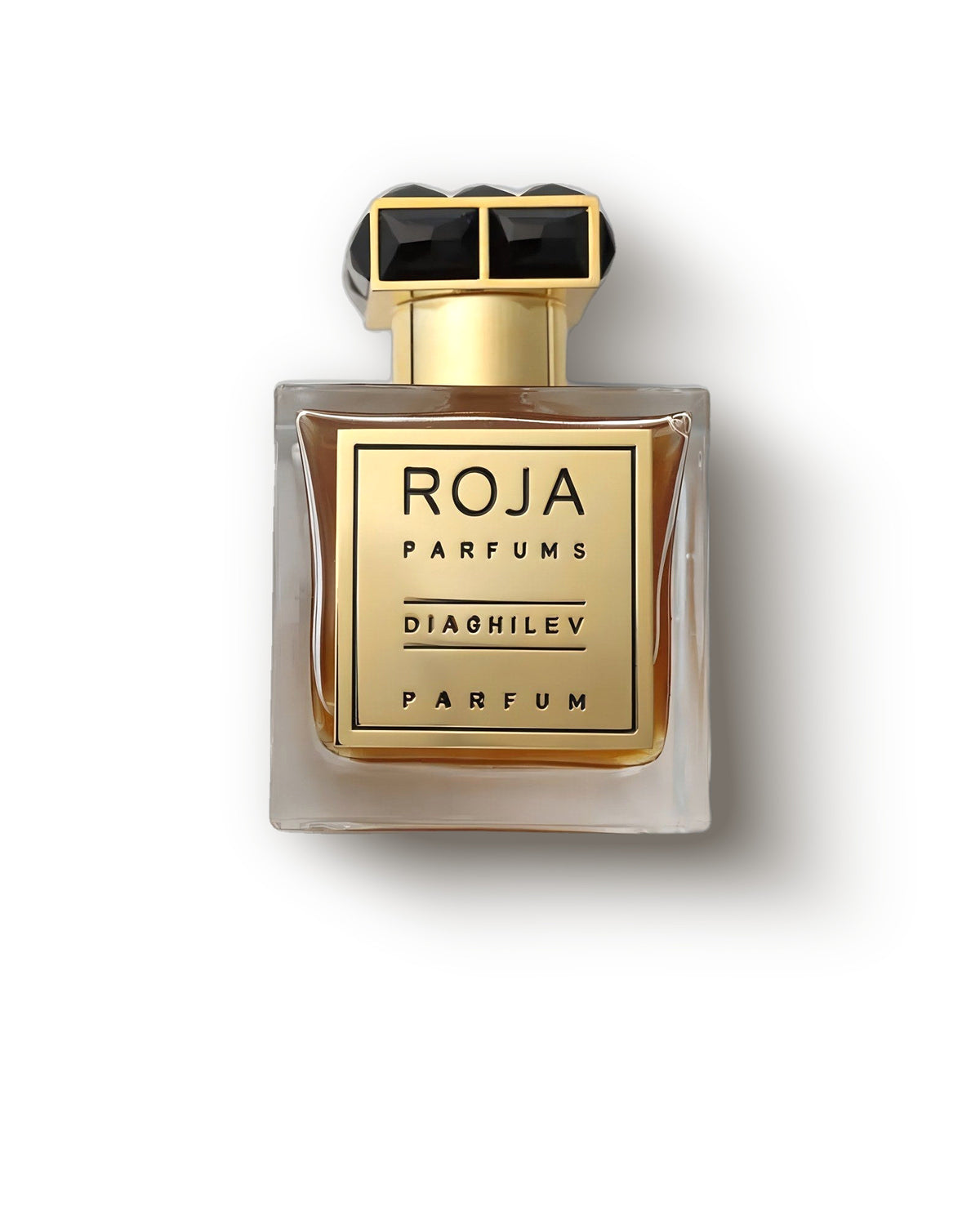 크림 배경 위 골드 라벨과 보석 장식 블랙 캡의 Roja Dove Diaghilev 앰버 보틀, 시프레 엑스트레 드 파르푸 디캔트