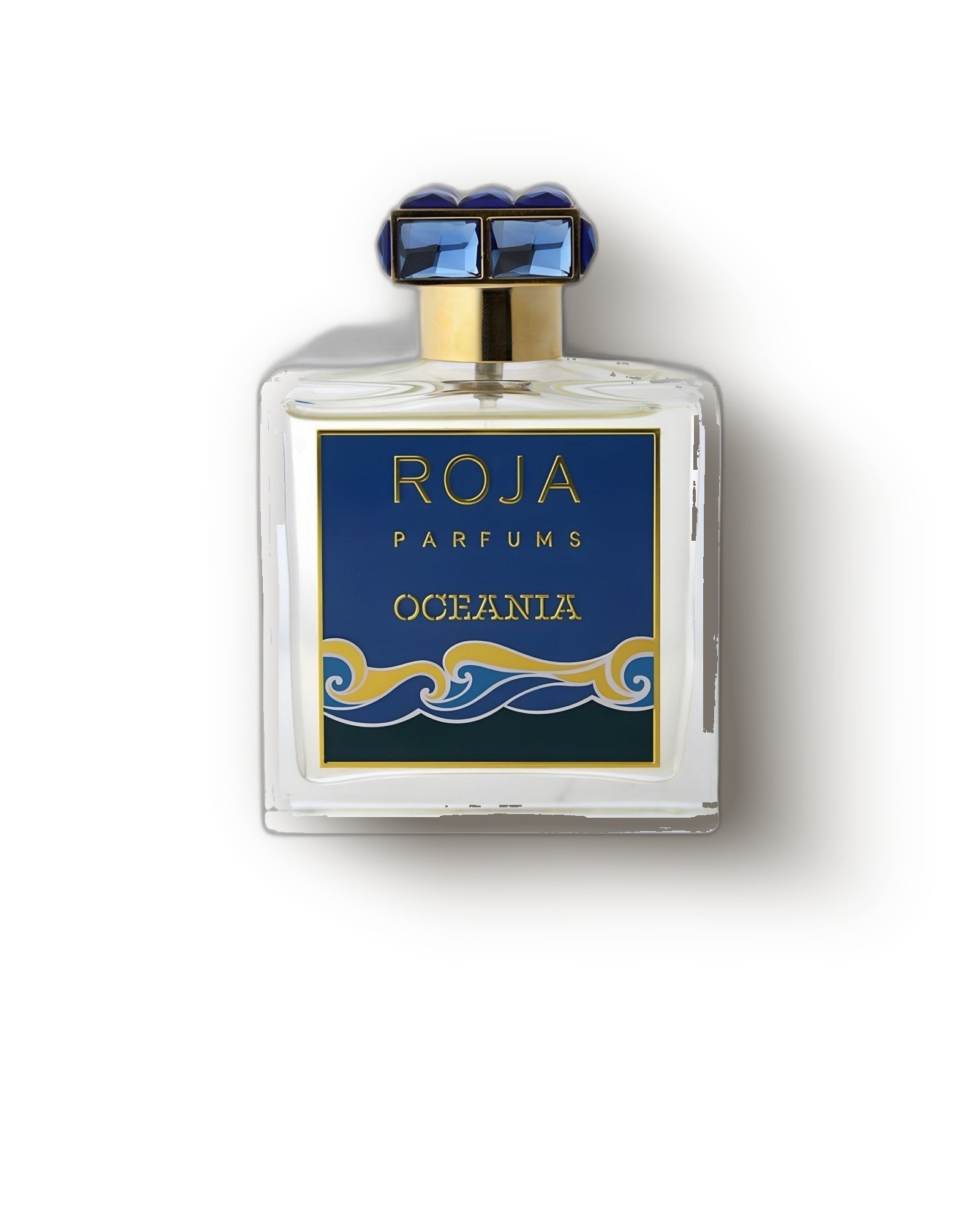 Roja Oceania flacon with blue jeweled cap and gold-wave label on a soft grey backdrop, aquatic niche perfume decant