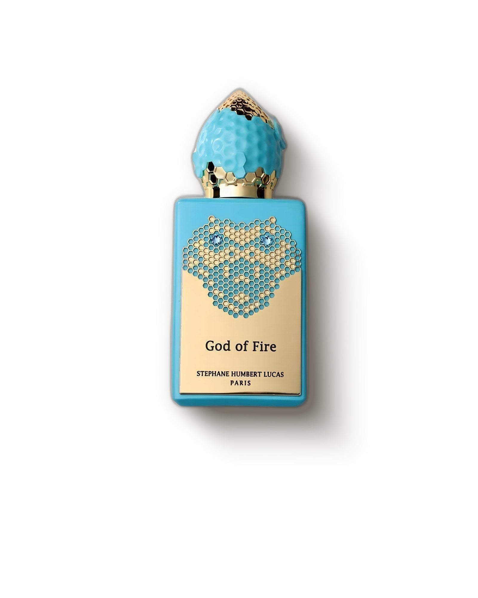 Stephane Humbert Lucas 777 God of Fire turquoise honeycomb bottle on pale grey, amber oud niche perfume decant
