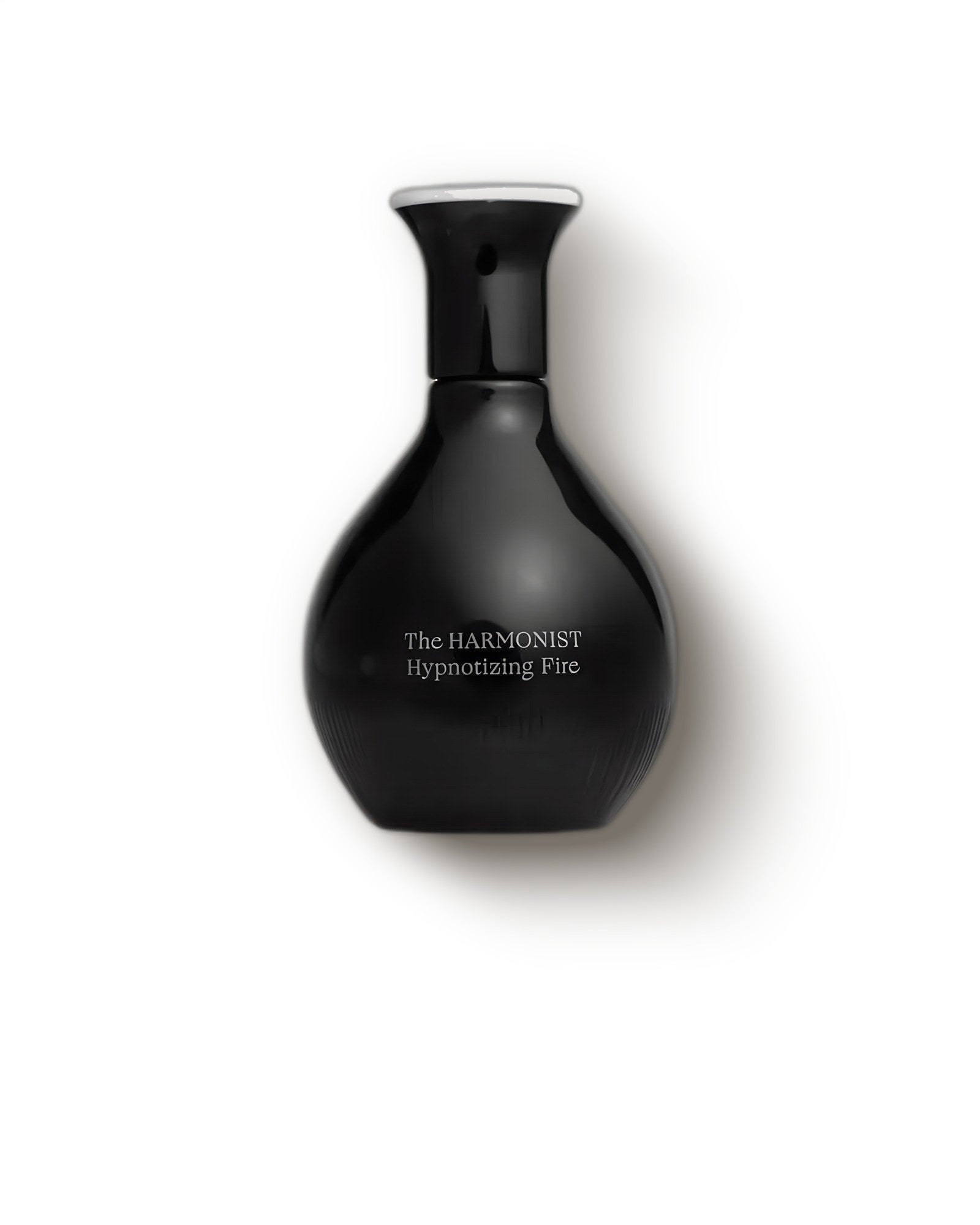 The Harmonist Hypnotizing Fire glossy black teardrop bottle on a pale backdrop, spicy oud niche perfume decant