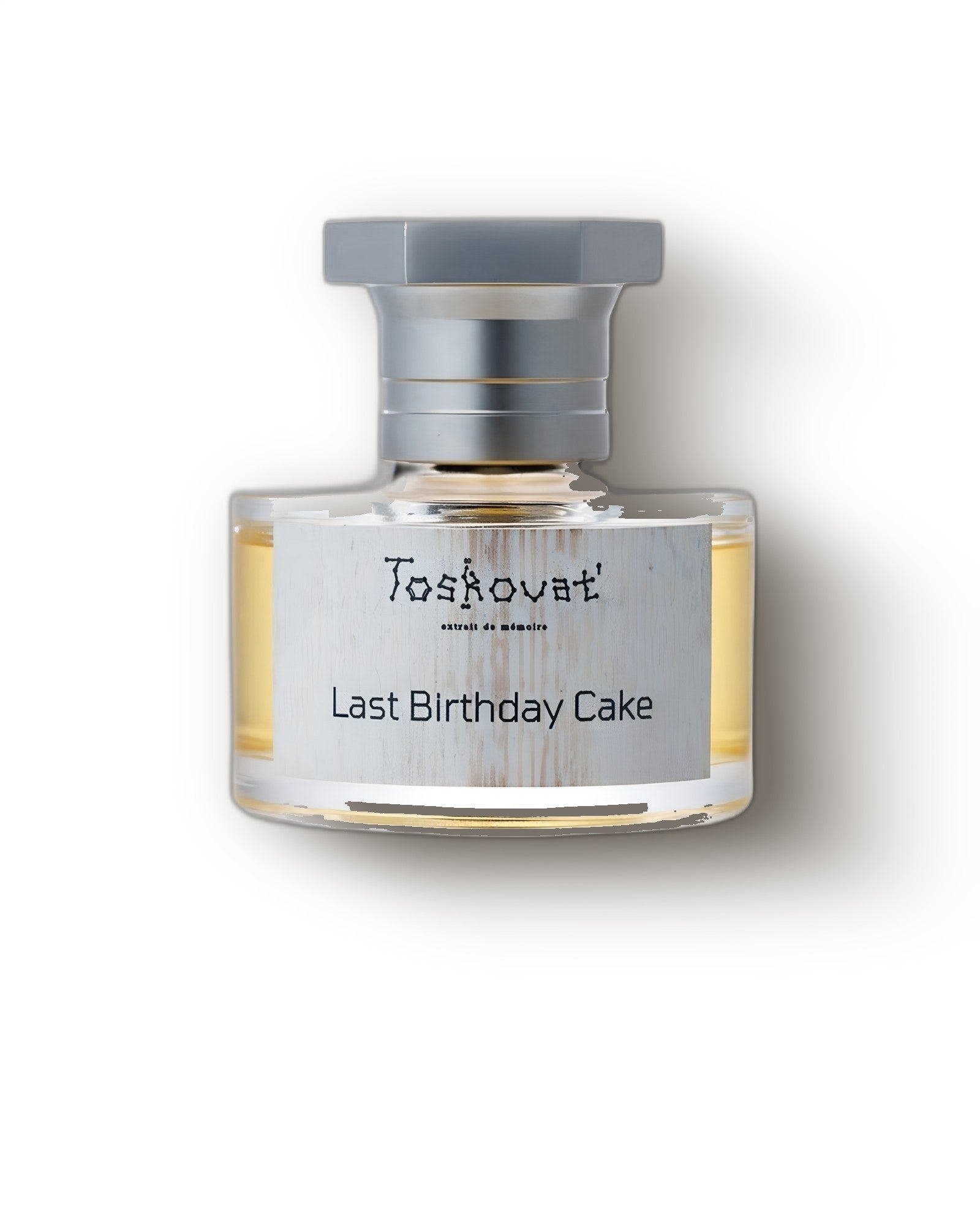 Toskovat Last Birthday Cake extrait bottle with brushed silver cap on soft cream backdrop, gourmand niche perfume decant