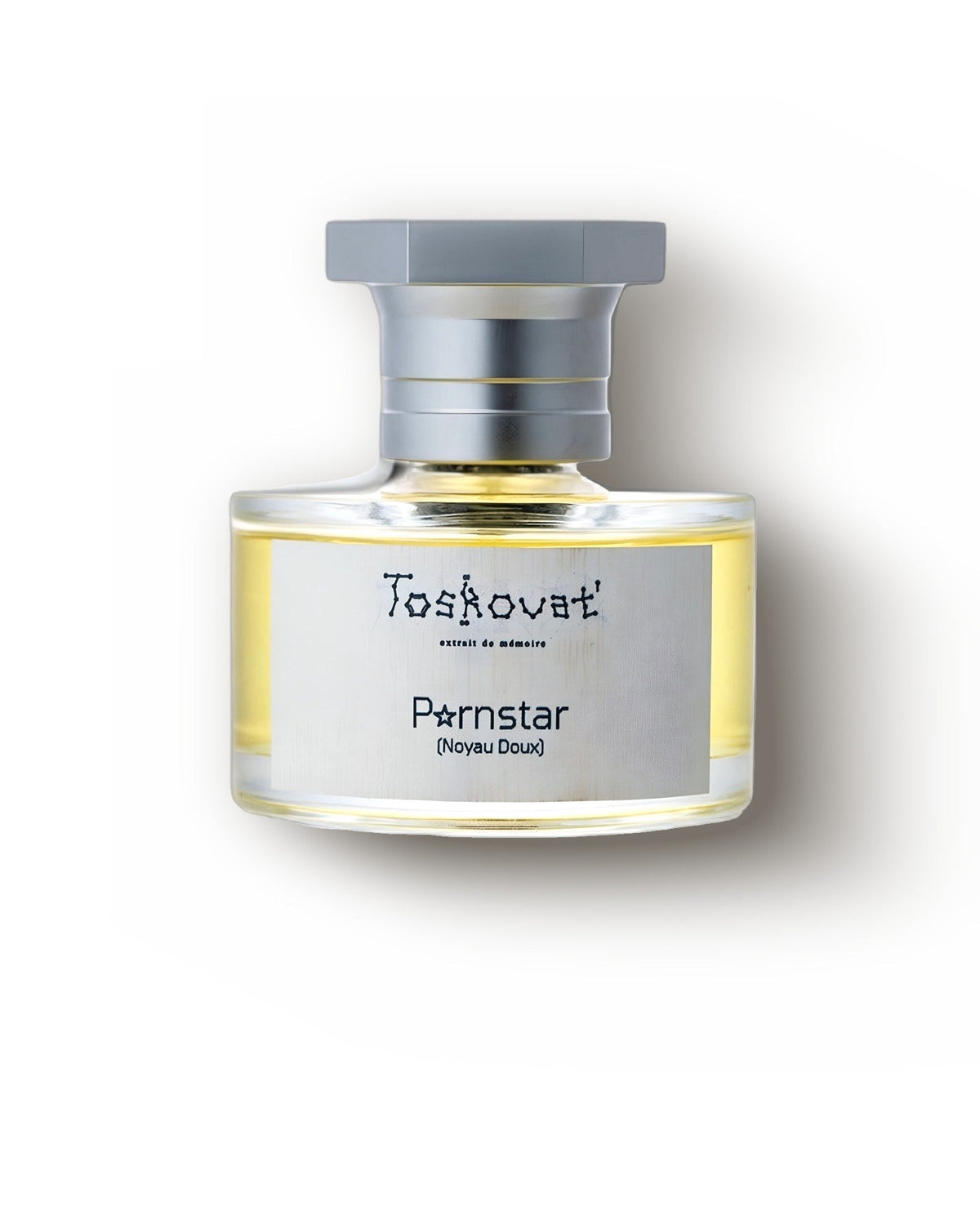 Krem zemin üzerinde fırçalanmış gümüş kapaklı Toskovat Pornstar Noyau Doux şişesi, gurme extrait de parfum dekant