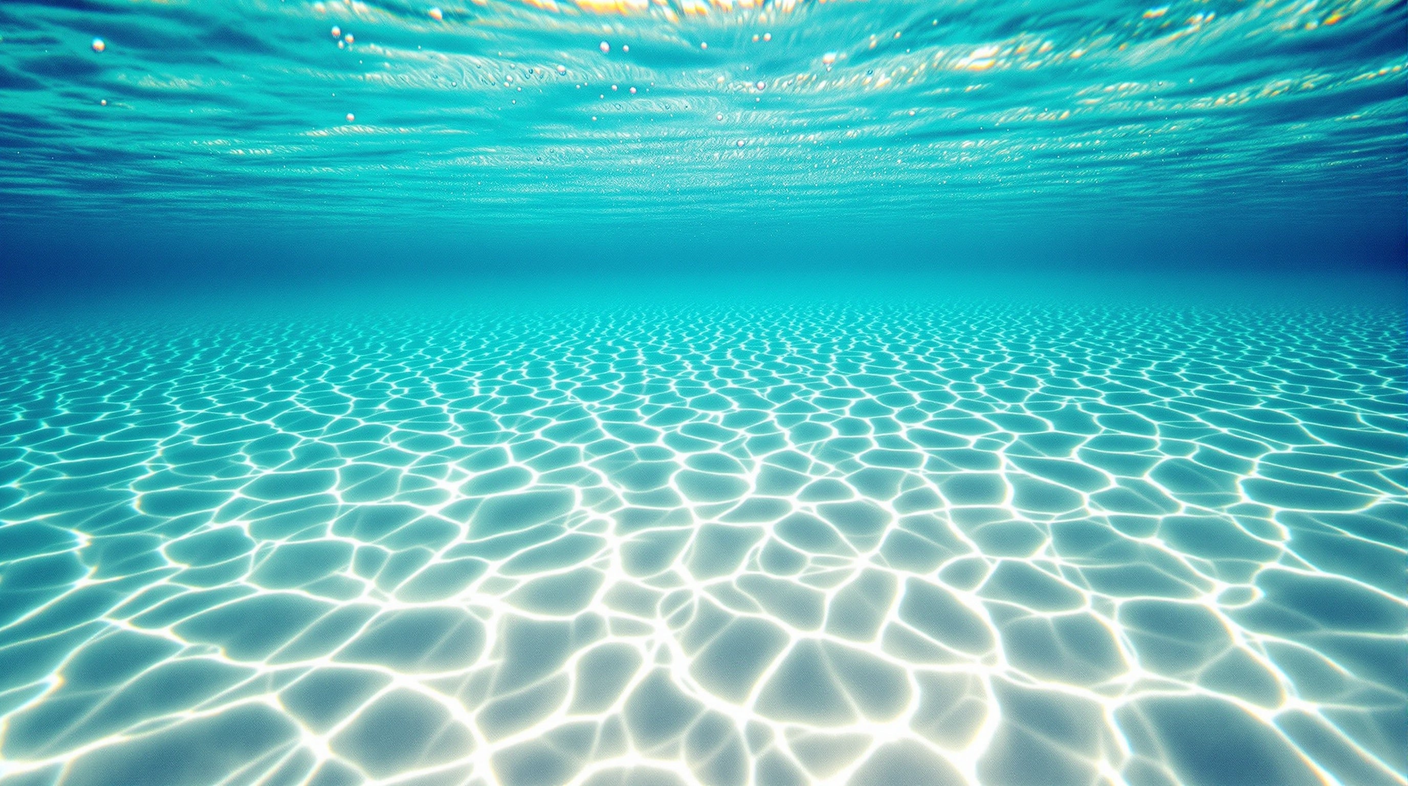 Sunlit turquoise shallows with dappled caustics over rippled sand, illustrating the best niche aquatic and marine fragrances.