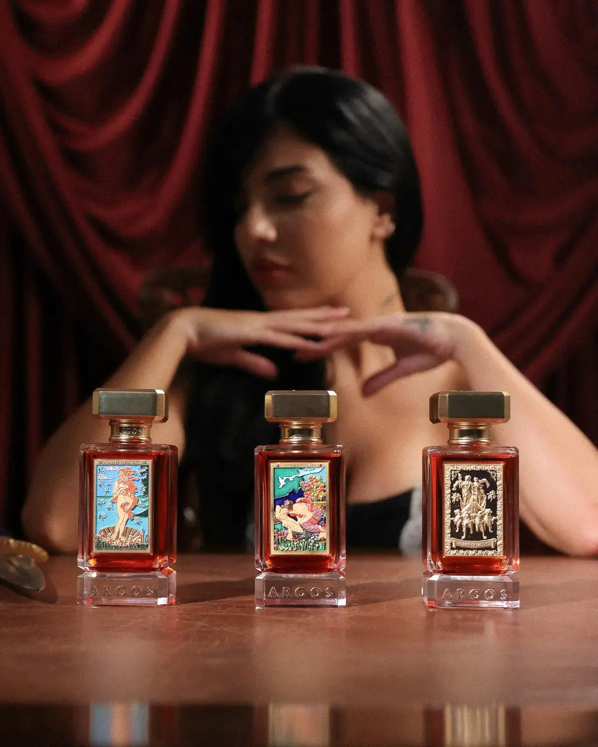 Argos fragrance trio: Birth of Venus EDP, Triumph of Bacchus EDP, and Triumph of Bacchus Extrait de Parfum 100 ml bottles side by side, luxurious mythical niche perfumes