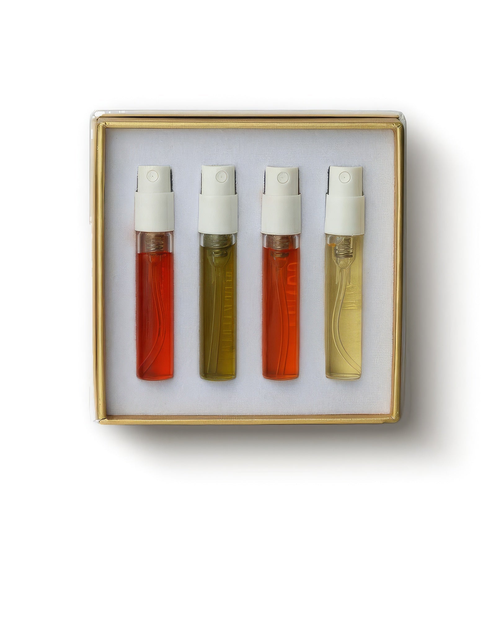 Gouttes Rares niche perfume discovery set, four 2ml spray vials of amber and gold juice in a gold-rimmed box