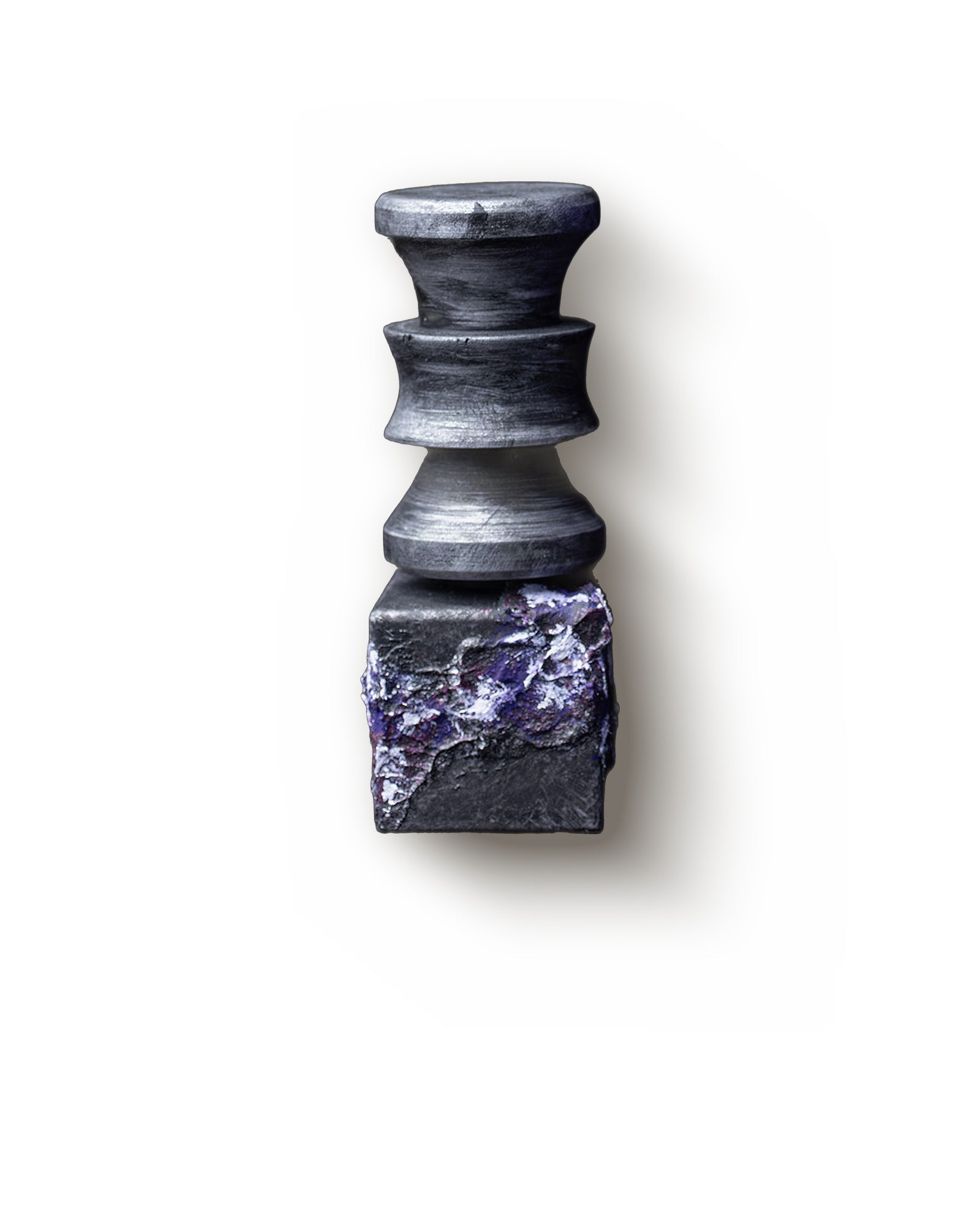 The Labels of Feelings flacon seen straight on, three silvered turned-wood discs stacked above a block crusted in violet and white, against a plain pale ground.