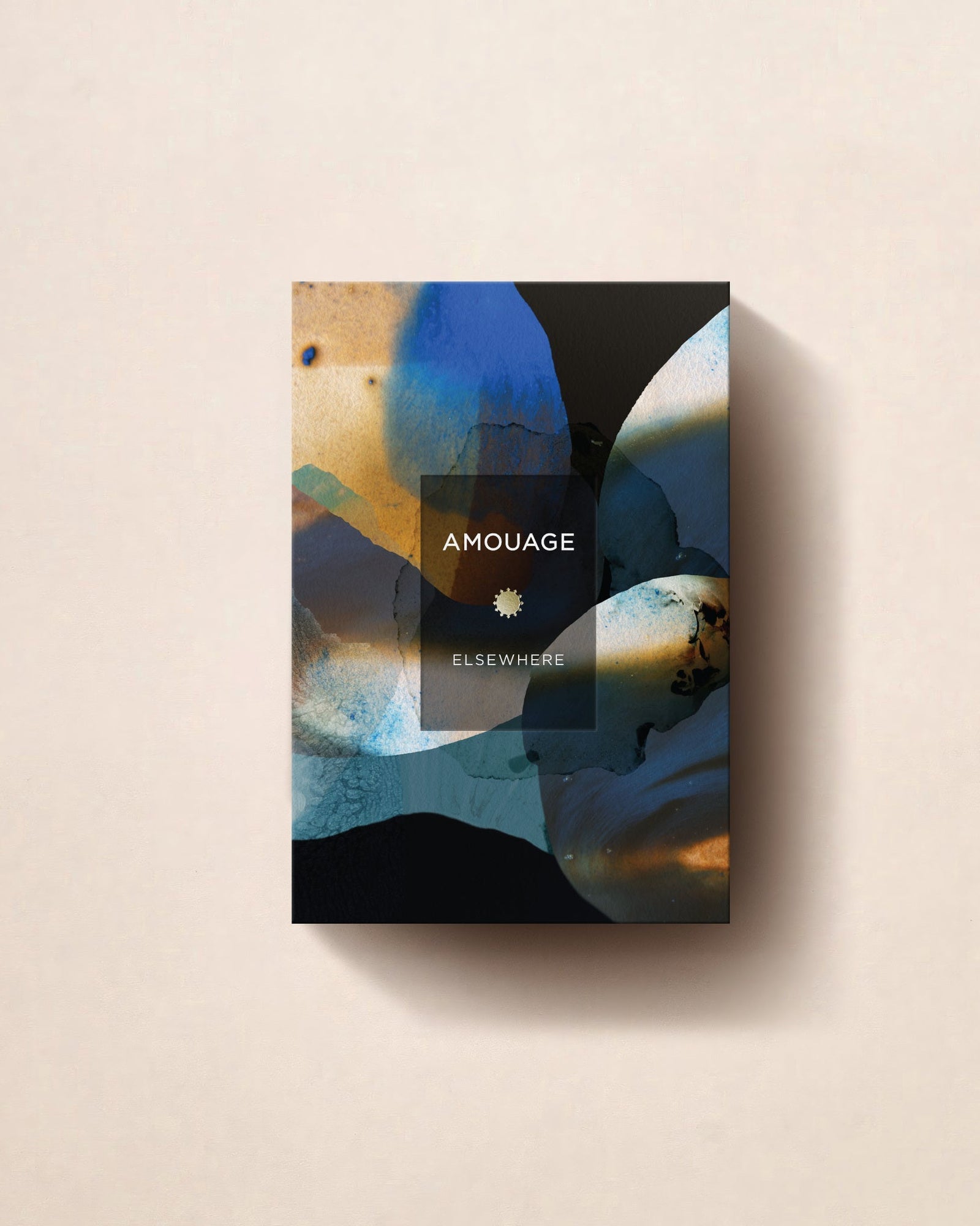 The Amouage Elsewhere carton standing on a pale cream ground, its abstract blue and ochre artwork wrapping the front panel.