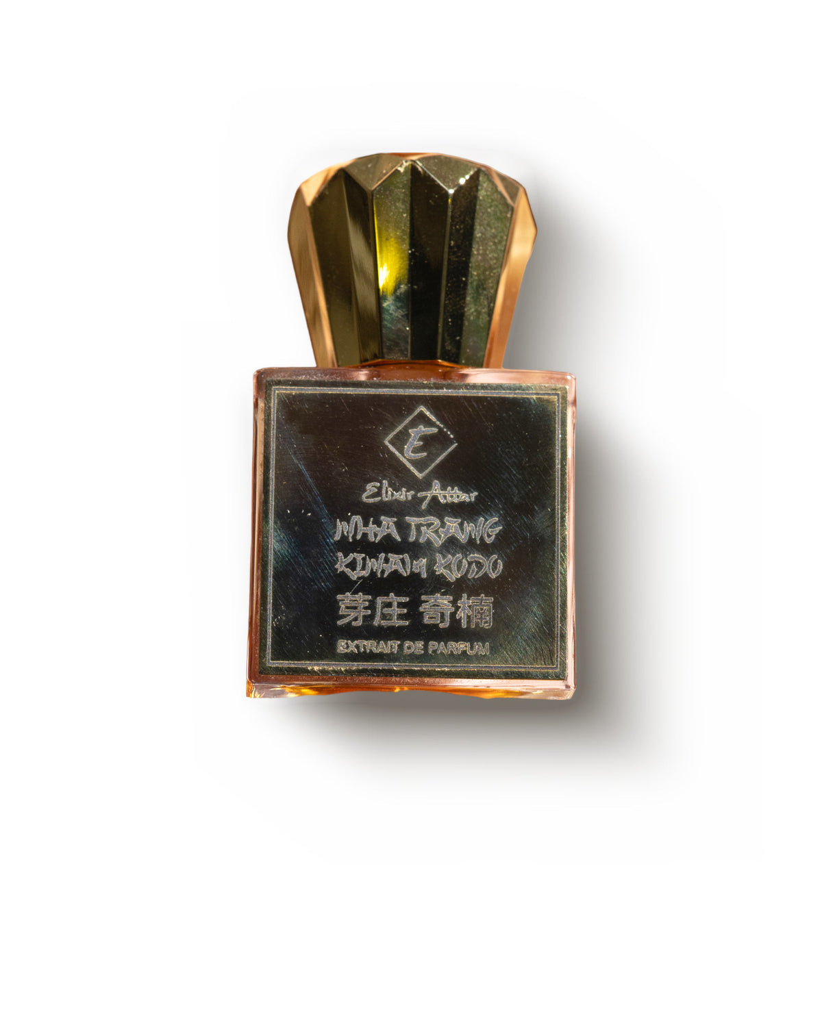 Elixir Attar Nha Trang Kinam Kodo, a square extrait de parfum flacon under a faceted gold crown cap, its dark engraved gold plate reading Nha Trang Kinam Kodo and 芽庄 奇楠