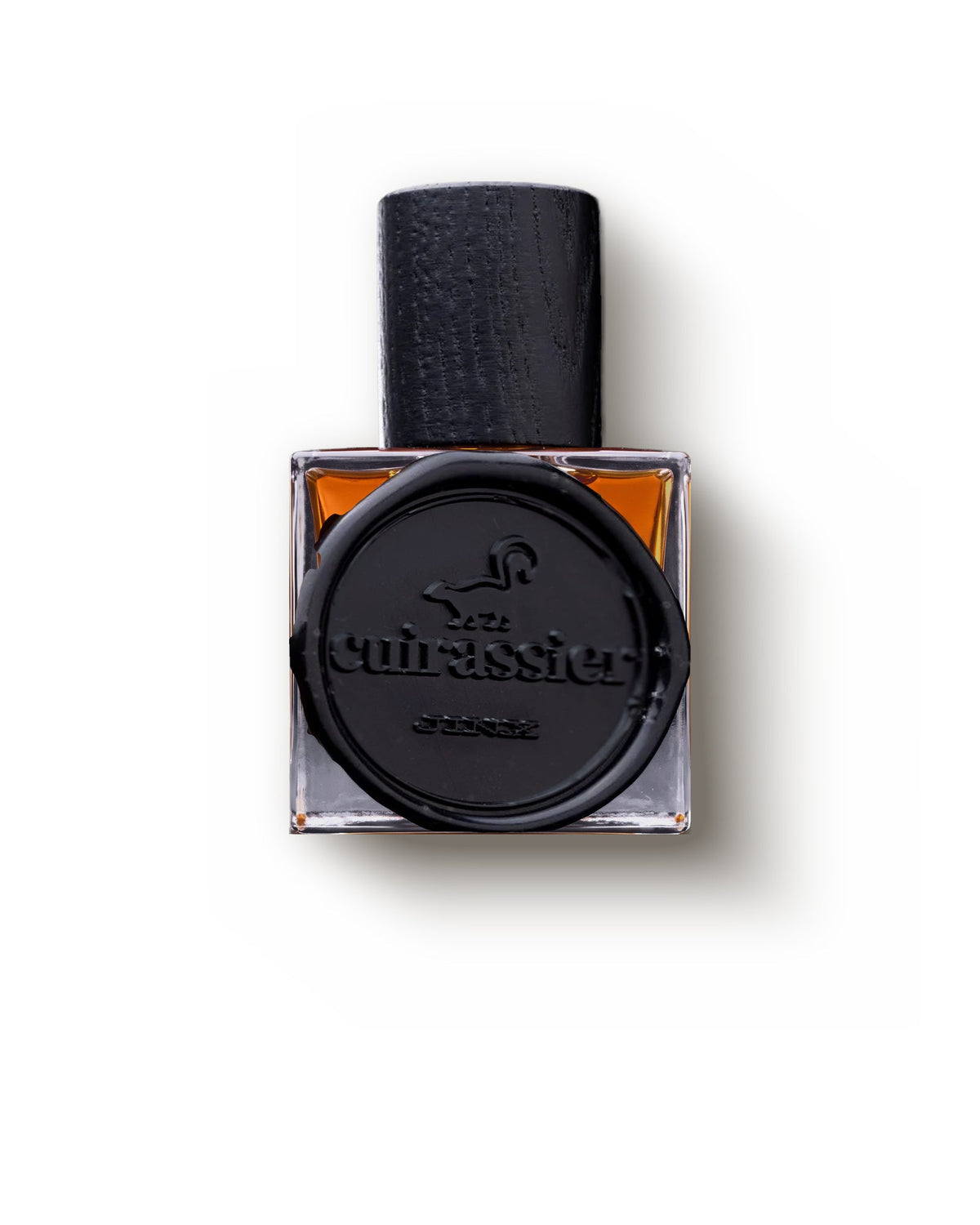 Jinx Cuirassier, front view: a thick clear glass cube of amber juice with a dark wooden cap and a black wax seal stamped cuirassier and JINX.