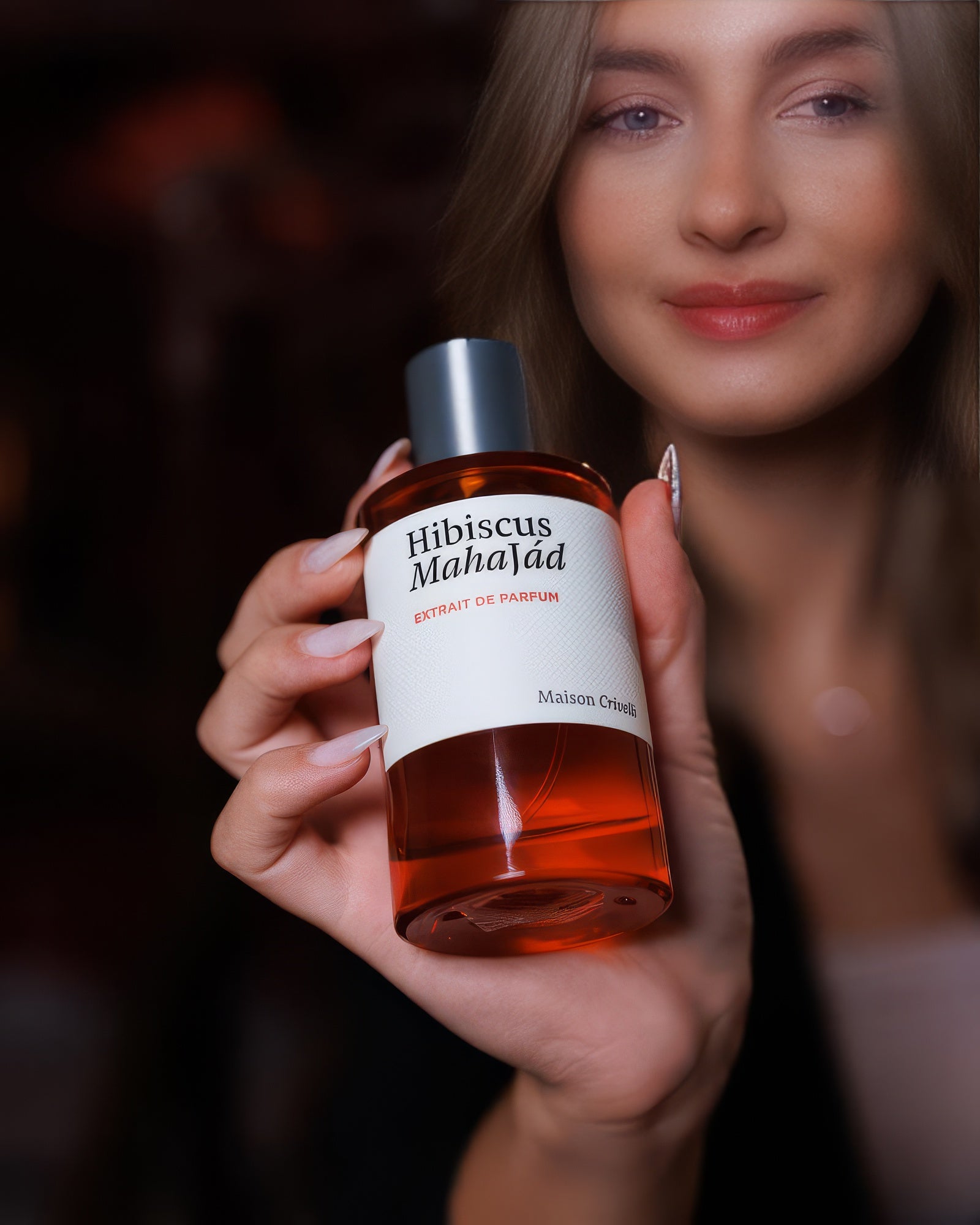 Blonde model holding the Maison Crivelli Hibiscus Mahajad flacon in warm light, tropical floral extrait de parfum sample